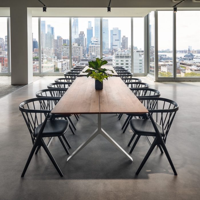 Dwight Funding's Manhattan office, with a long communal table and floor-to-ceiling windows overlooking the city skyline